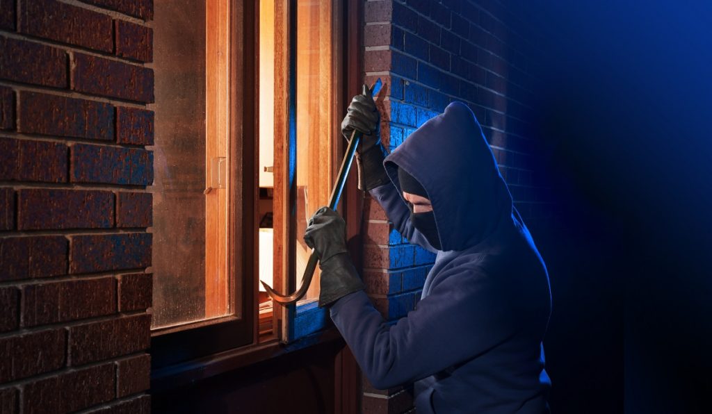 person trying to break into a house