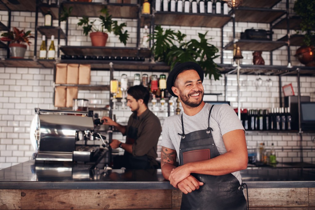 man smiling inside coffee shop