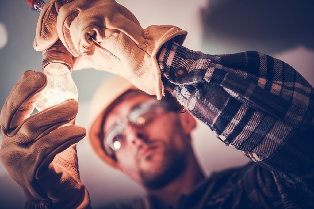 man changing light bulbs