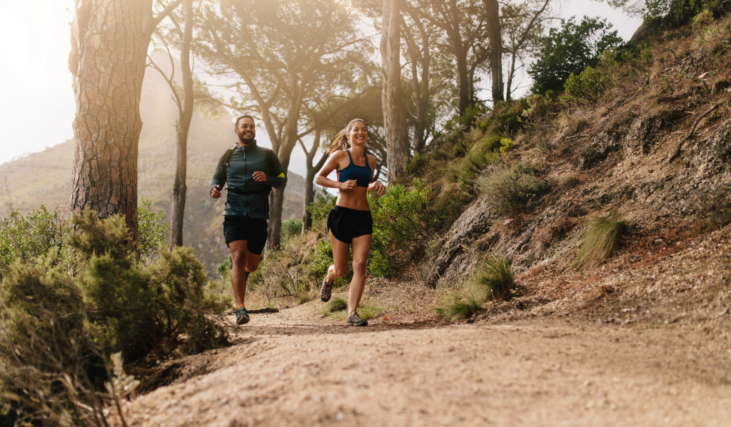 couple jogging in the woods