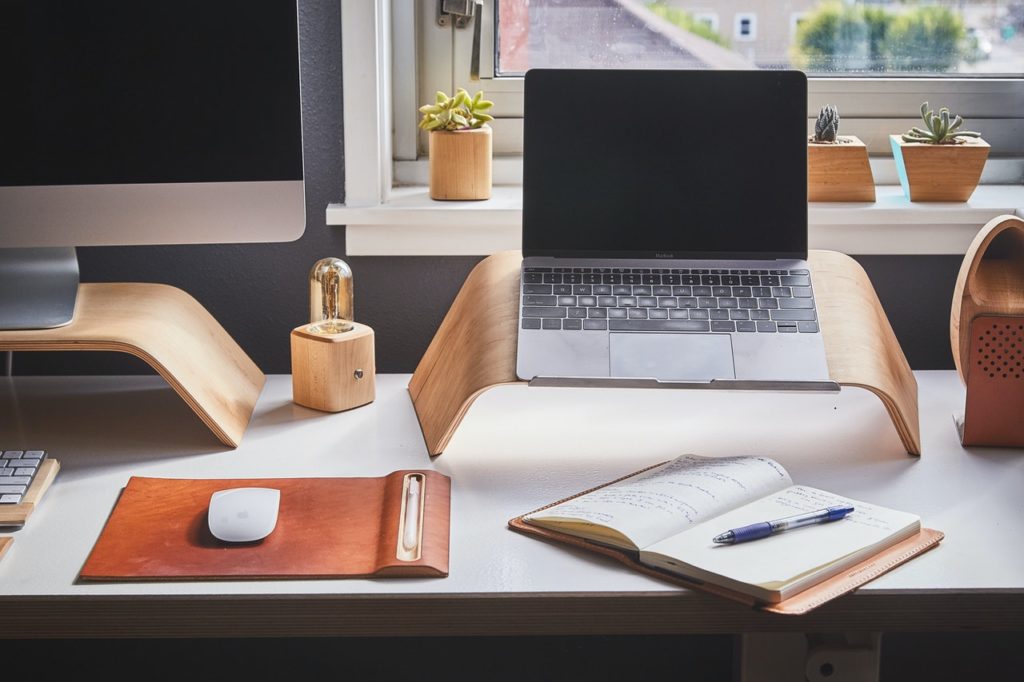 laptop and notebook on desk