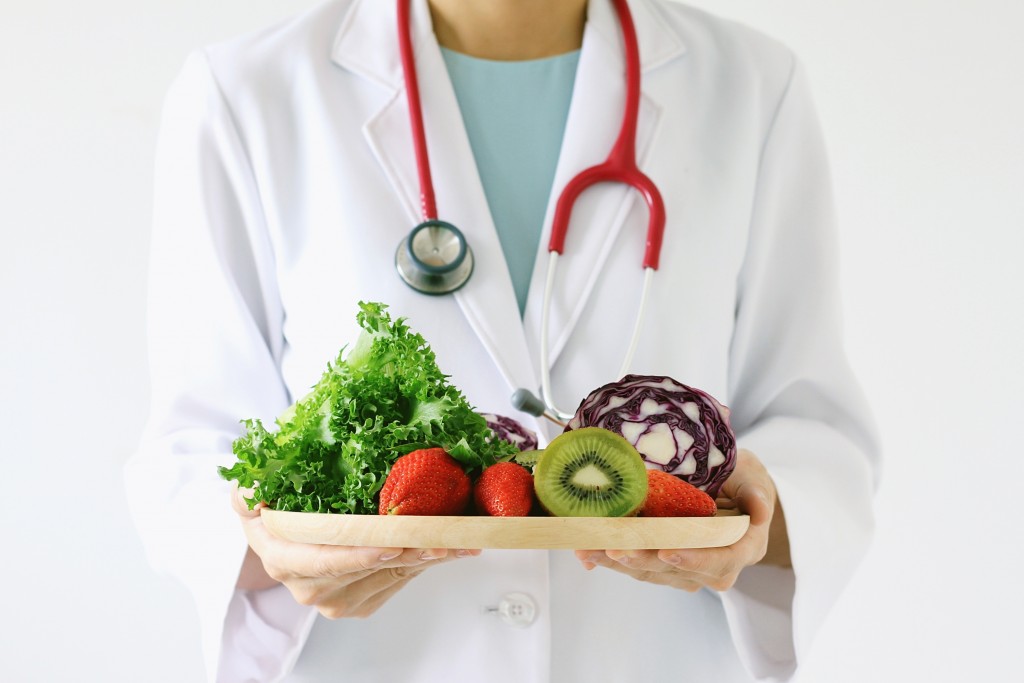 doctor holding fruits and vegetables