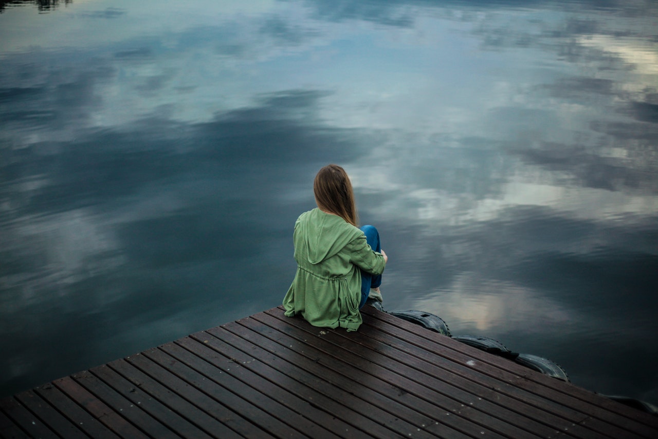 woman sitting alone on the dock