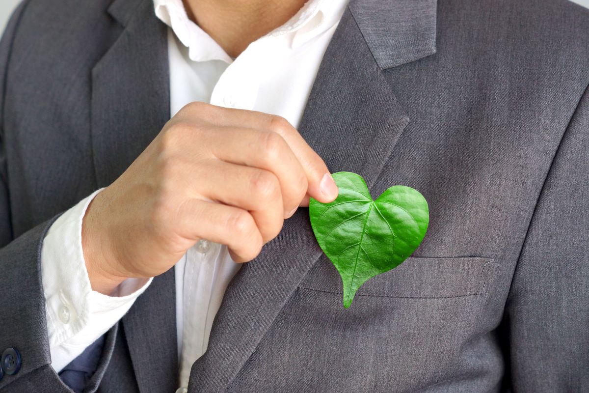 eco friendly concept holding heart shaped leaf