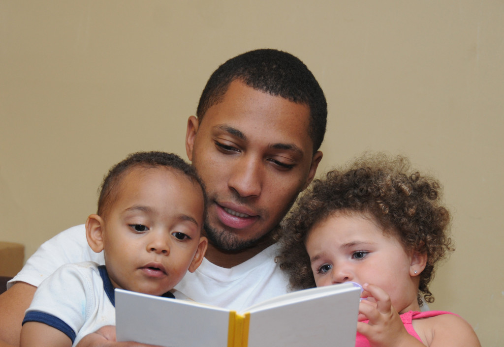 father reading story to children