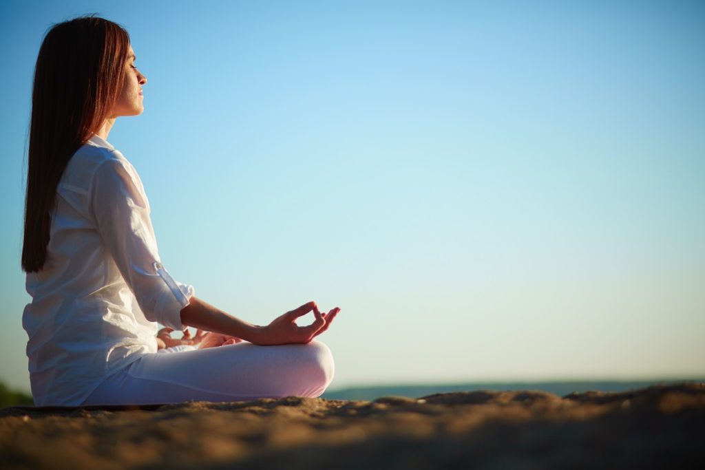 woman doing yoga outside