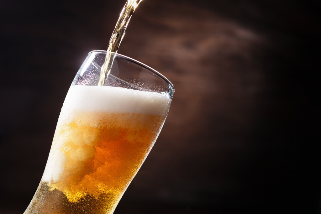 beer being poured in a glass