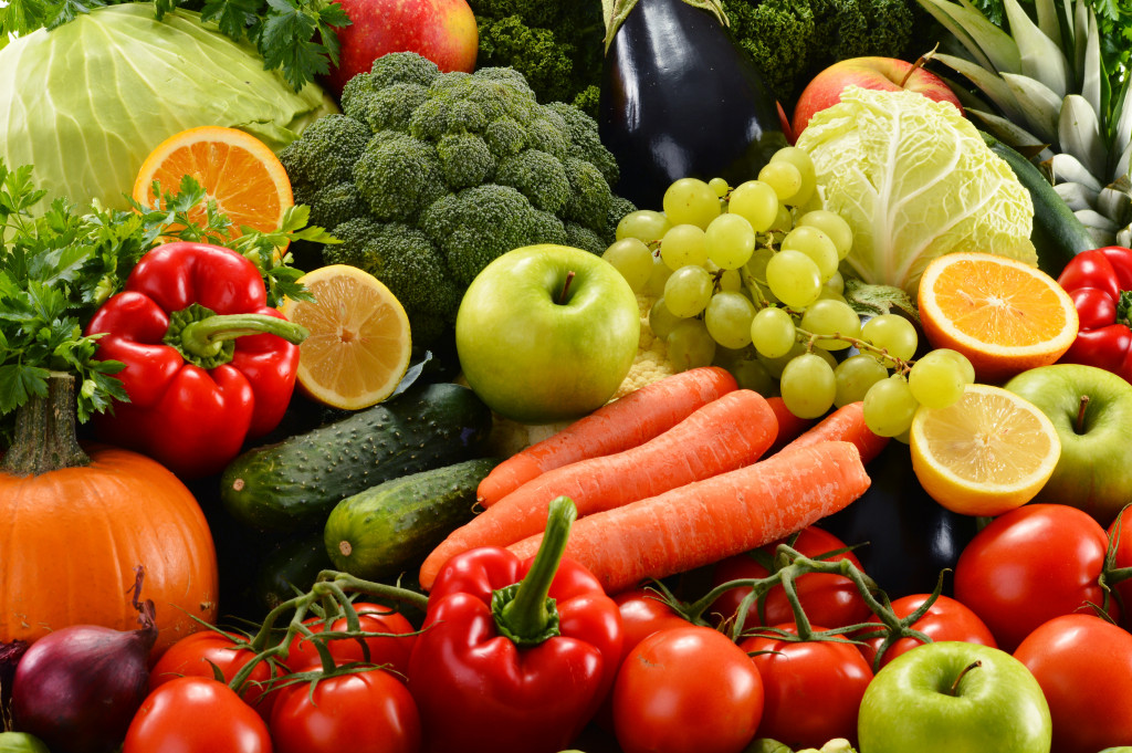 different kinds of fruits and vegetables laid out on a table