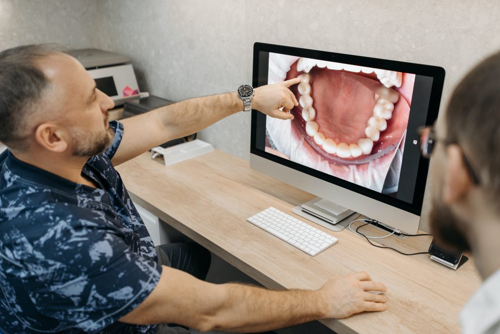 dentist pointing at his monitor