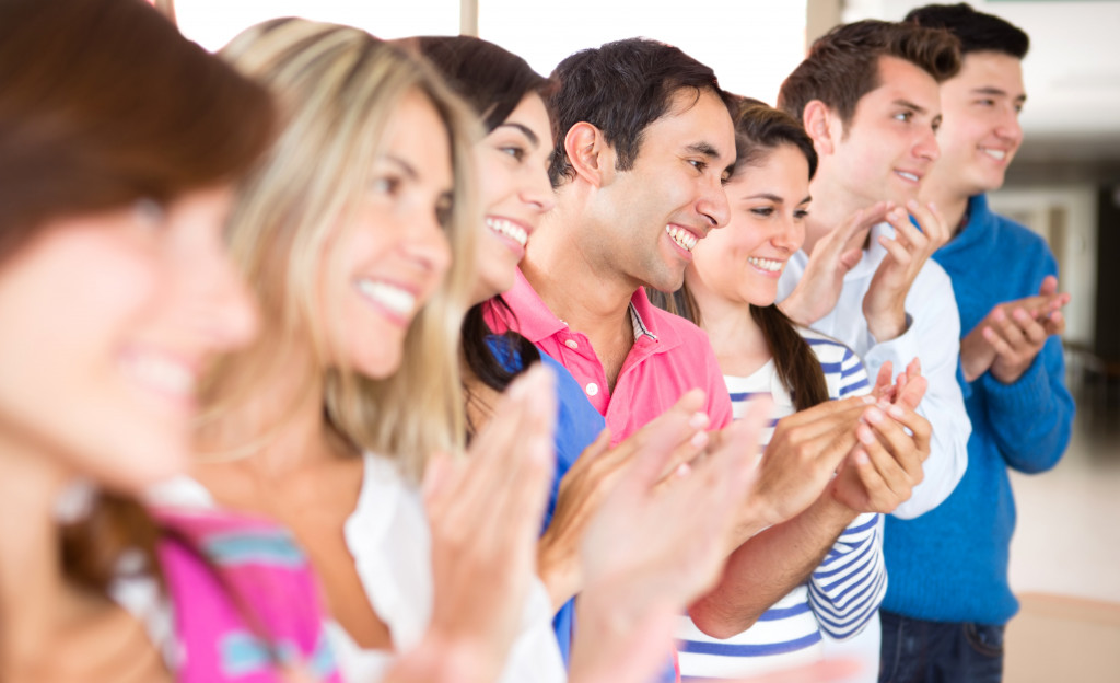 A support group applauding a person for sharing experience