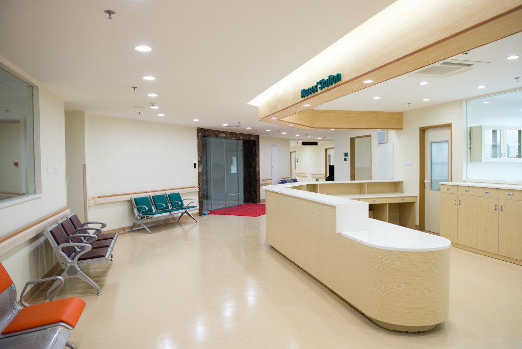 Reception area of a healthcare facility with a front desk and chairs in the waiting area.