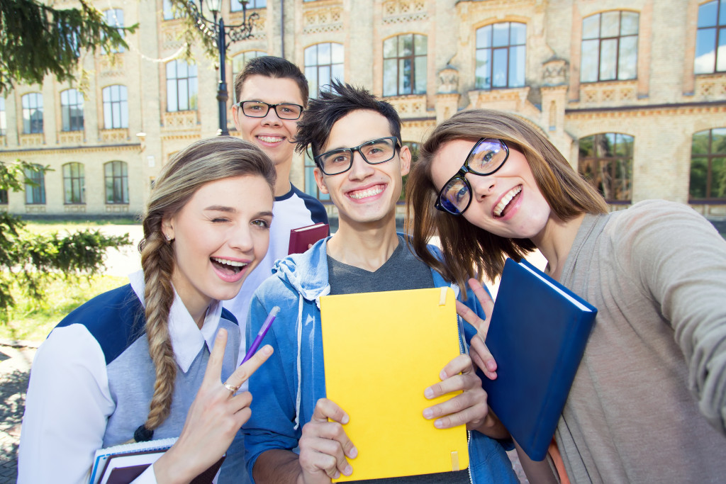 Young students smiling outside the university.