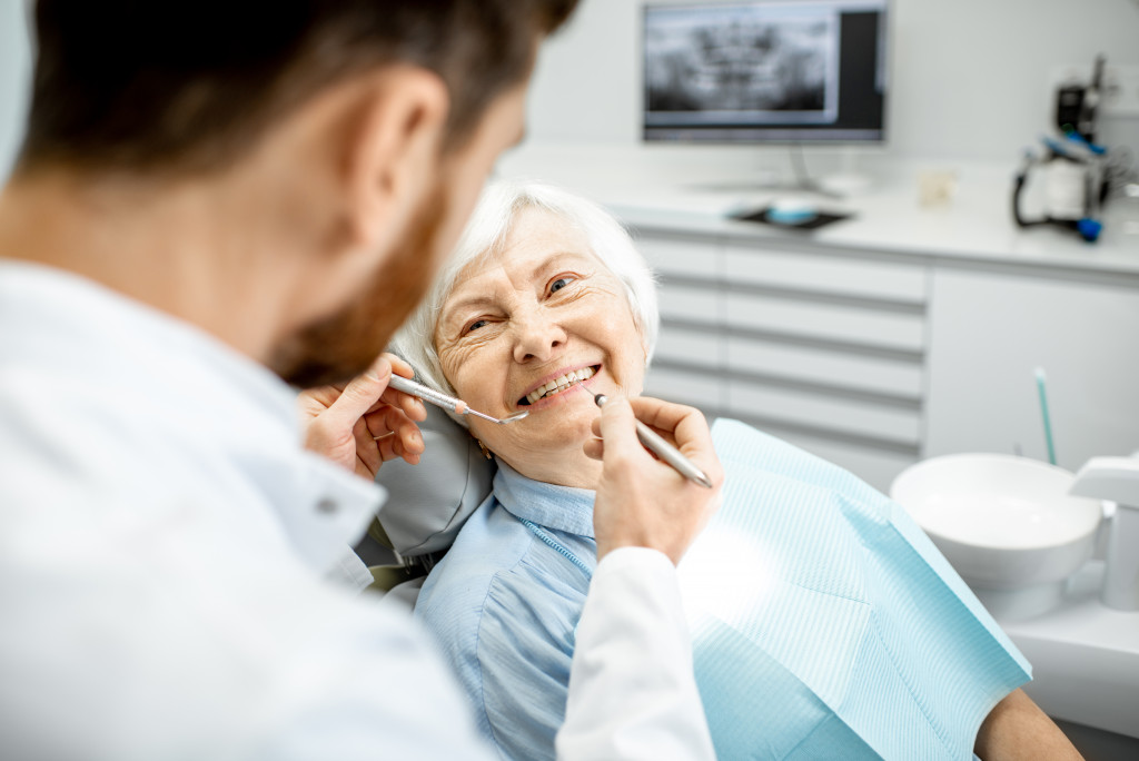 Elderly woman with dentist