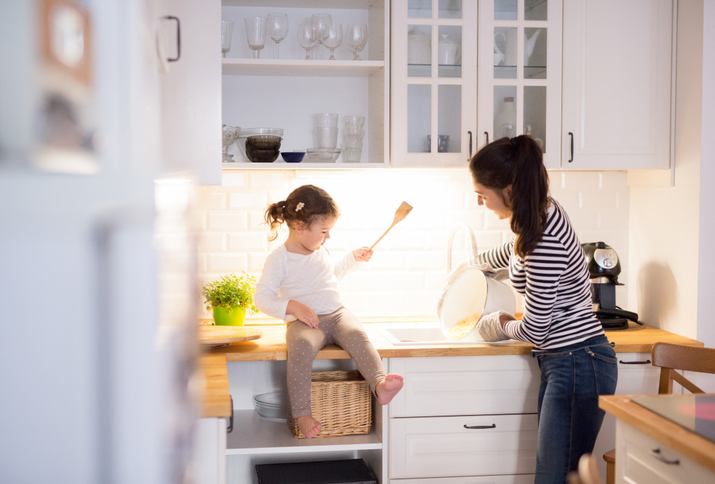 A mother and daughter preparing food in the kitchen