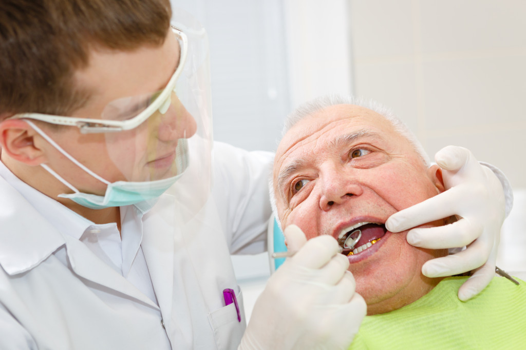 old man getting dental checkup