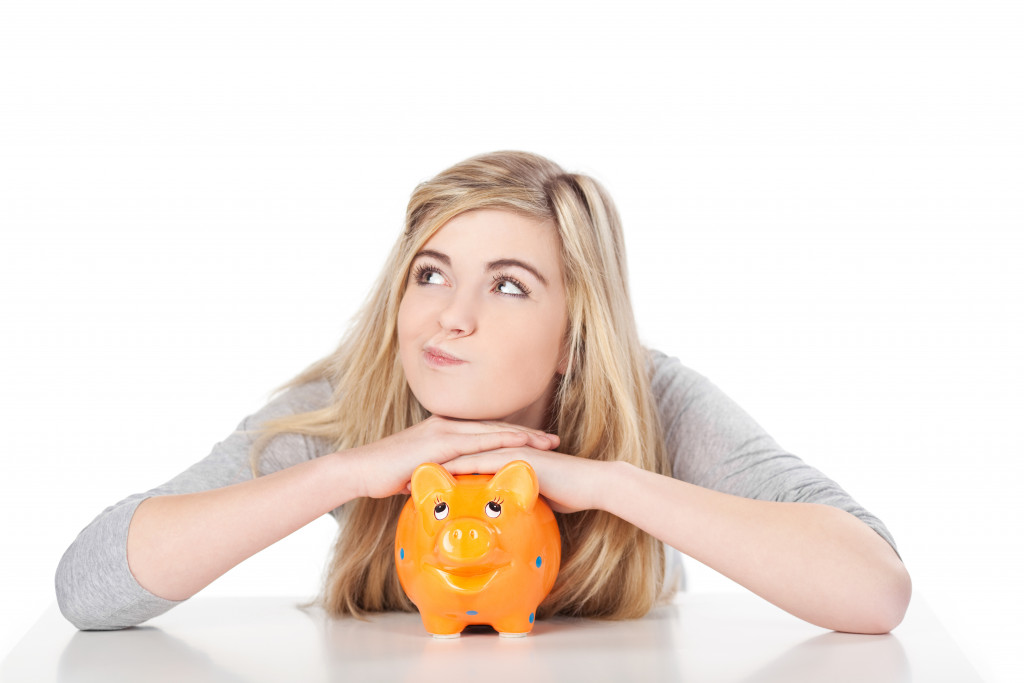 Woman holds piggy bank