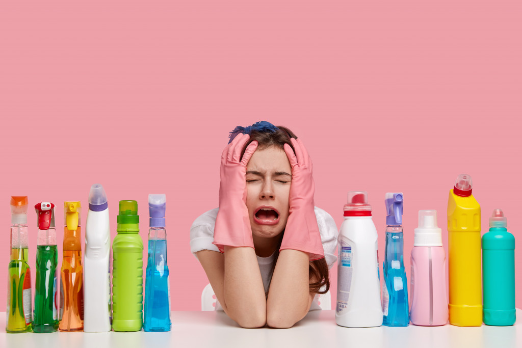 woman with houhold cleaning products