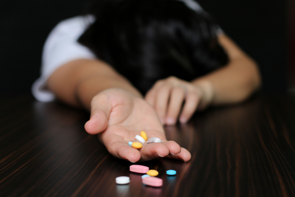 A woman with pills addiction