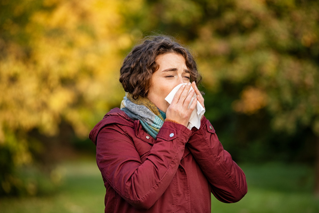 Woman coughing while covering her mouth