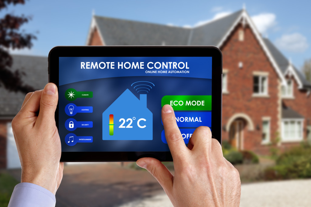man controlling home climate control systems using tablet