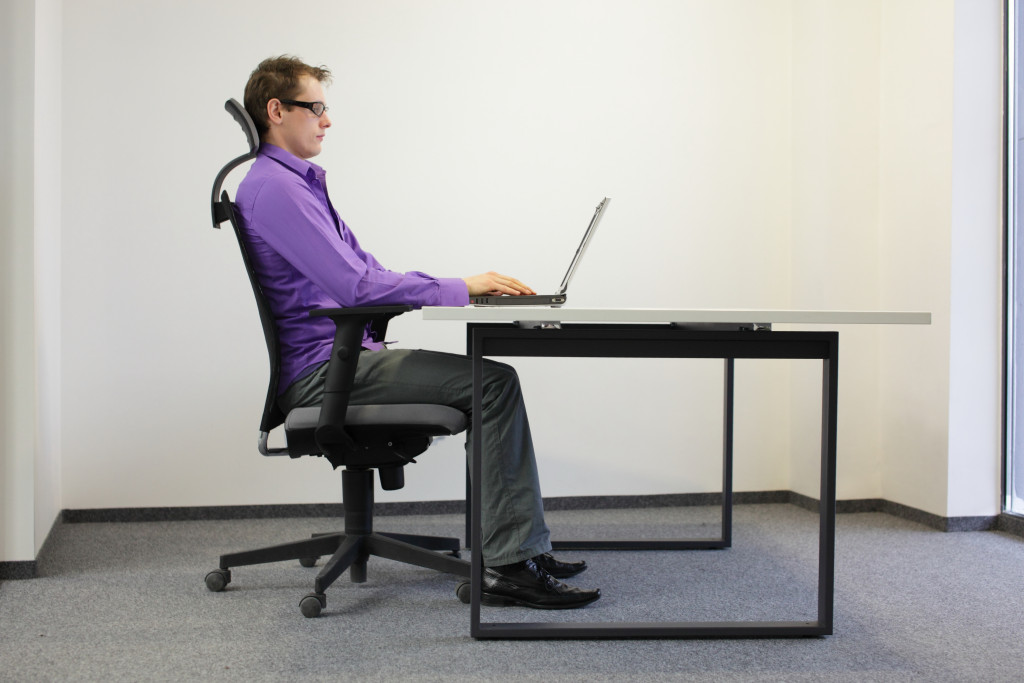 A man sitting in an ergonomic chair while working