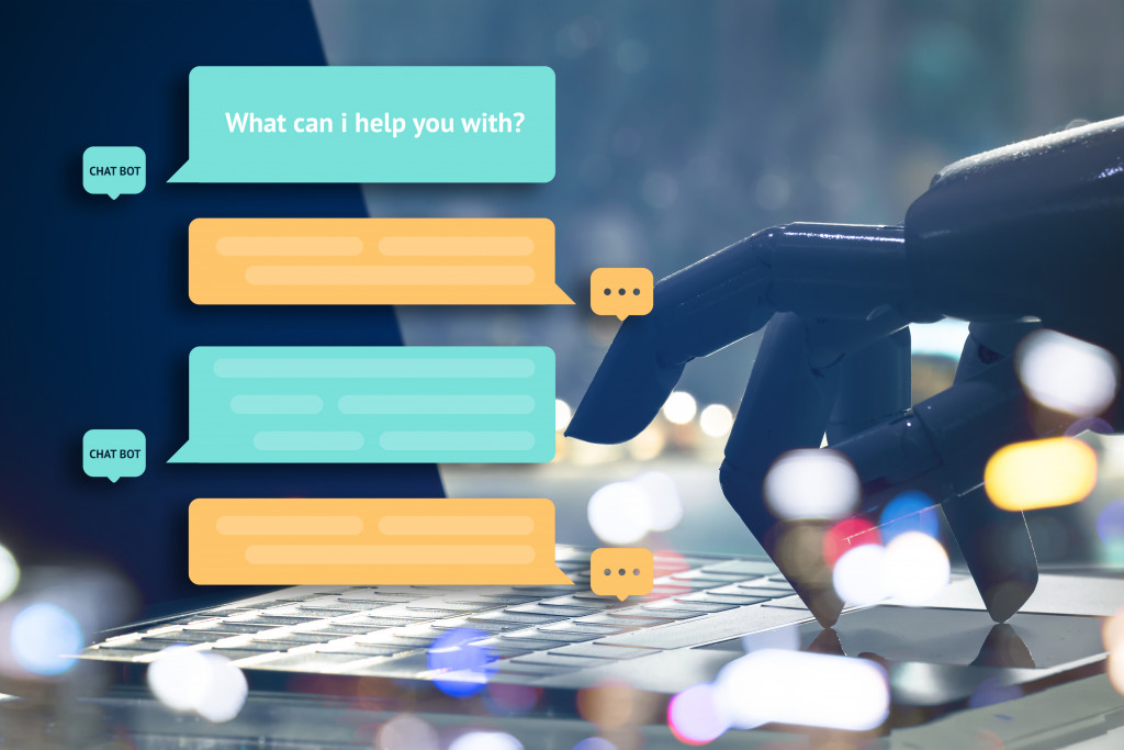 A concept of chatbot, a robot hand using a laptop to chat and reply