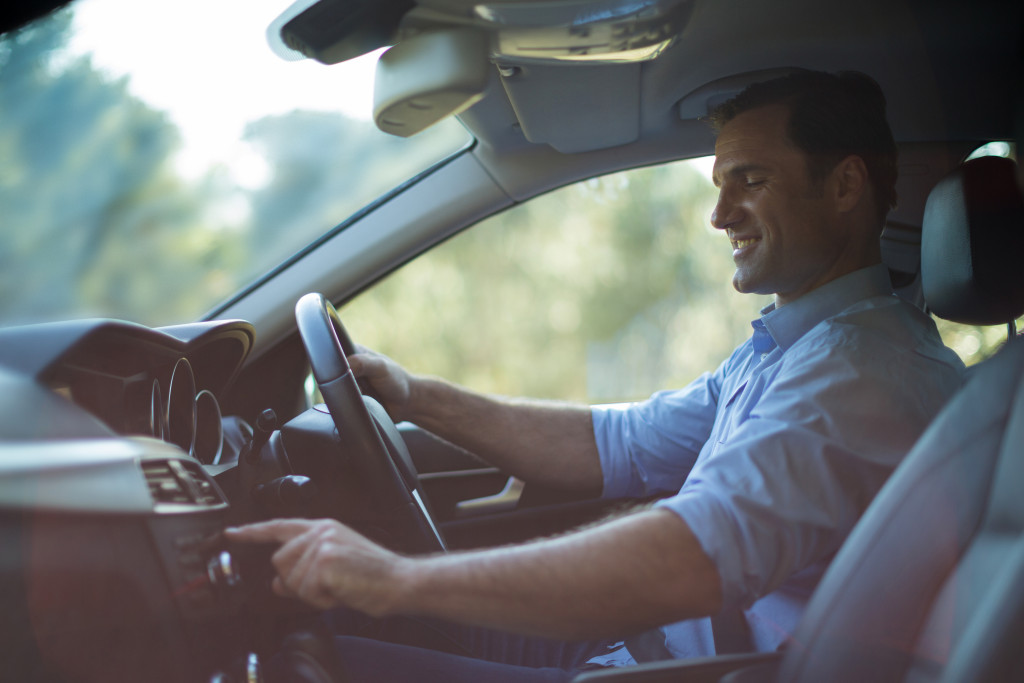 man having a peaceful time inside his car