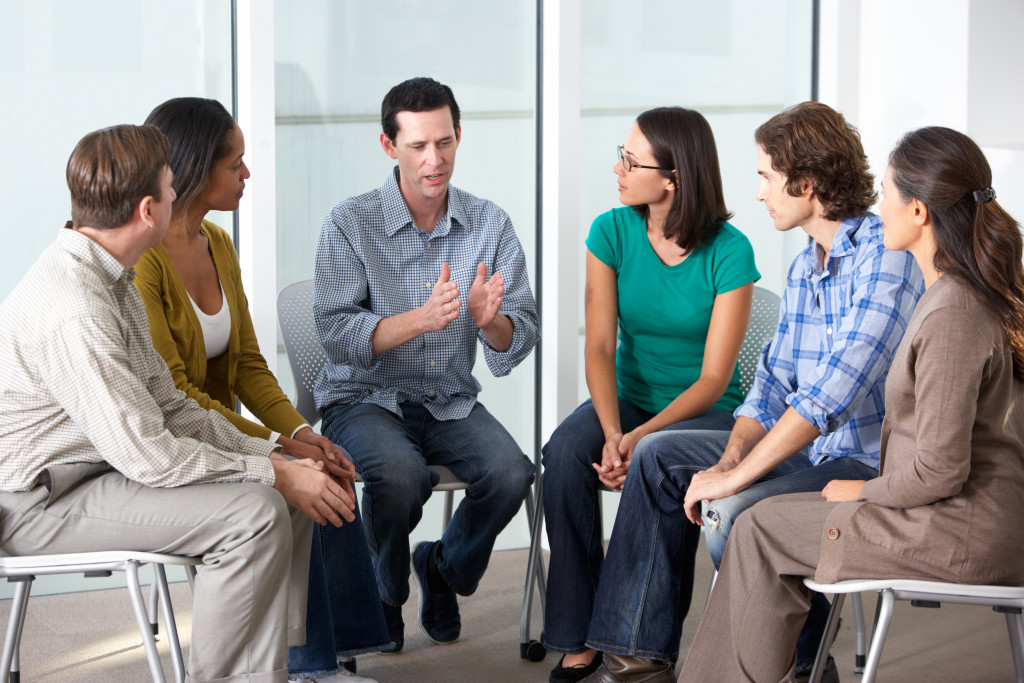 man talking in support group meeting