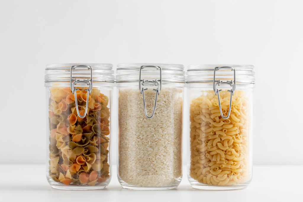 glass containers with pasta and rice