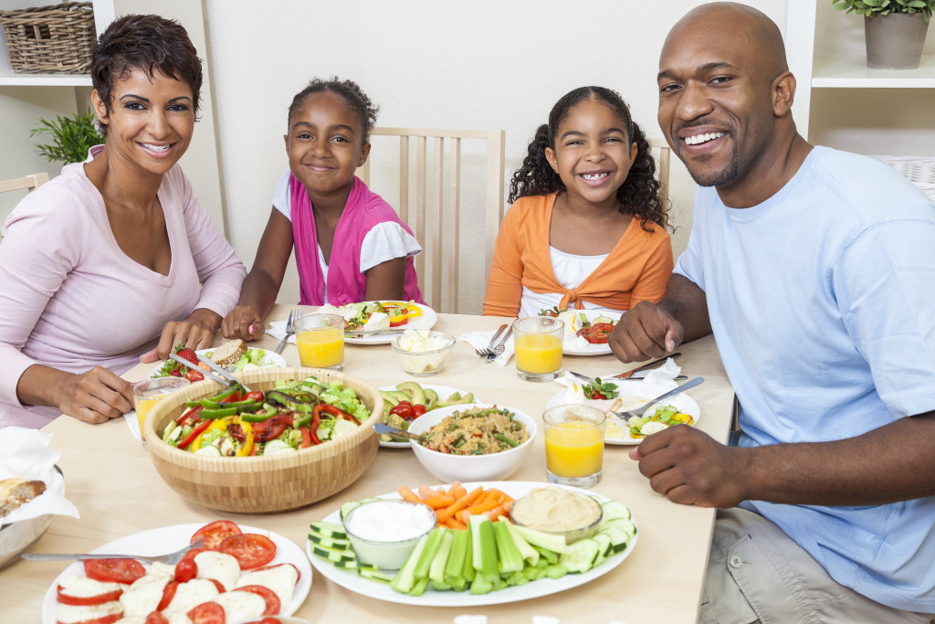 Family eating a healthy meal of fruits and vegetables.