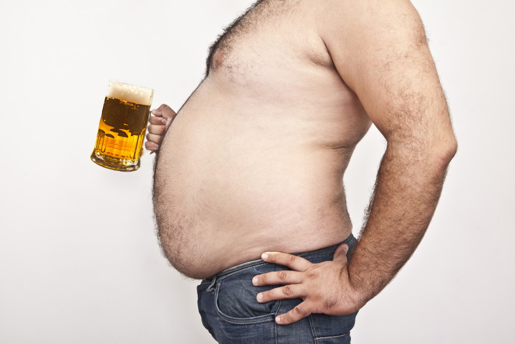 Obese man and beer mug
