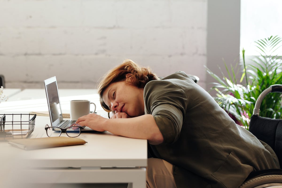 woman sleeping in front of a laptop
